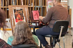 Photograph showing the artist demonstration in a painting one class.
