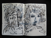 A drawing done in a moleskine sketchbook.  The drawing is gray scale, and is of two faces, one on each page. The one on the left was drawn with my left hand and the one on the right with my right hand. The drawing on left is an abstracted female and the drawing on the right is an abstracted male. There is a number of abstract shapes surrounding the two figures that look very chaotic.  I am ambidextrous- I drew this with both hands simultaneously.