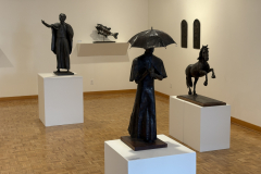 Wayne Williams installation, showing various sculptures in center of gallery and on back wall.